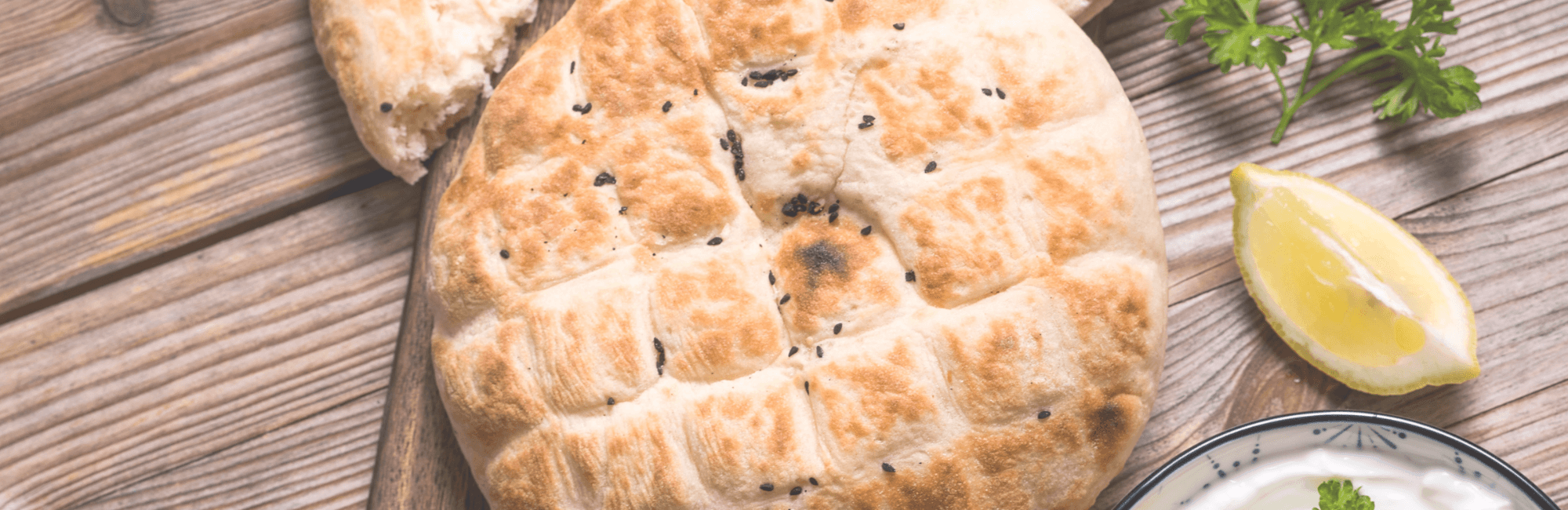Fladenbrot mit dunklem Sesam auf Holz